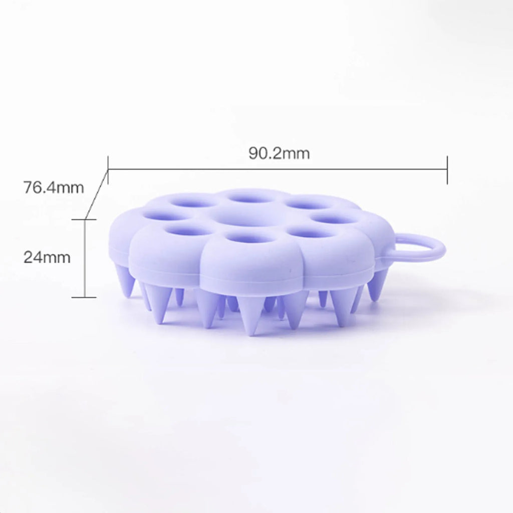 Silicone pet grooming brush with coloured ergonomic handle and flexible massage bristles for dogs and cats.