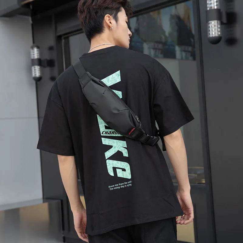 Black Oxford cloth waist pack with a phone pocket and ID pocket, shown with dimensions 12cm high by 27cm wide.