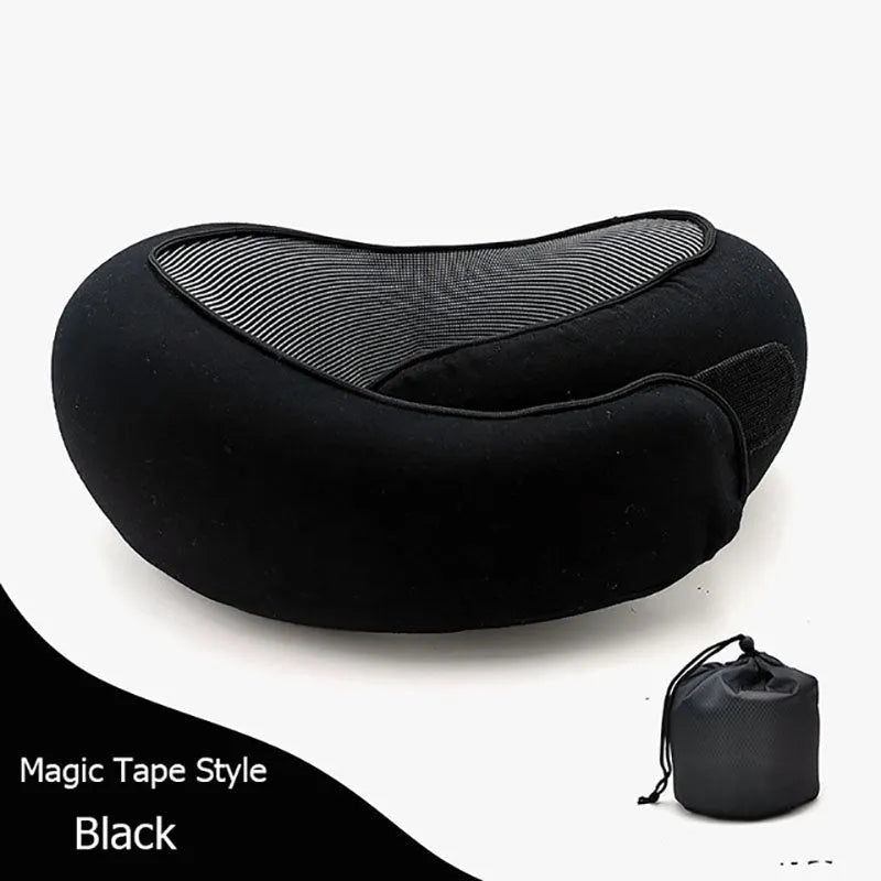 Navy blue U-shaped travel neck pillow with memory foam, shown rolled up next to its carry bag.