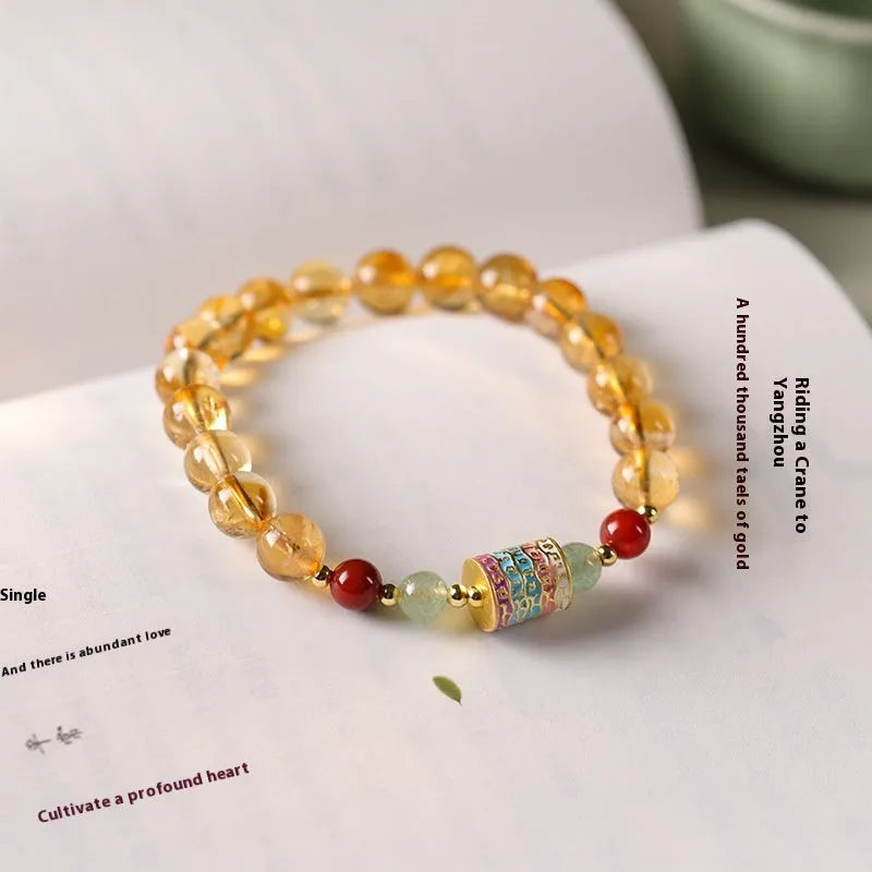 Yellow citrine prayer wheel bracelet with 8mm beads on wrist