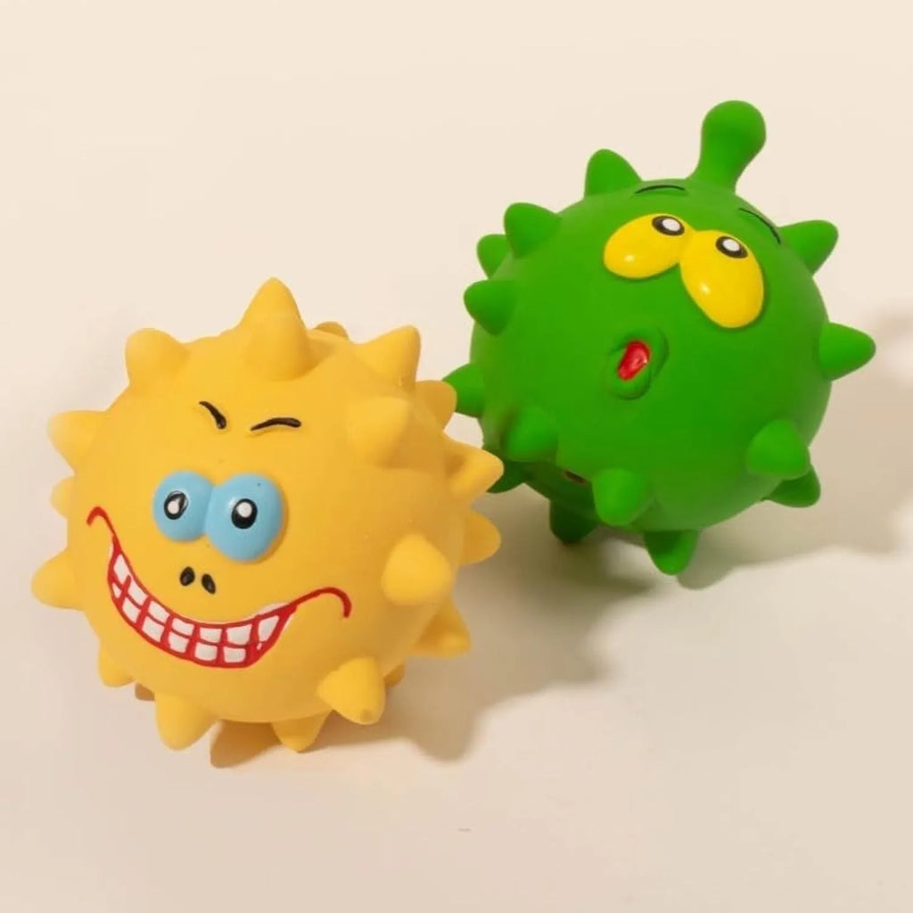Set of four coloured latex squeaky dog balls with cute faces, shown next to a dog.