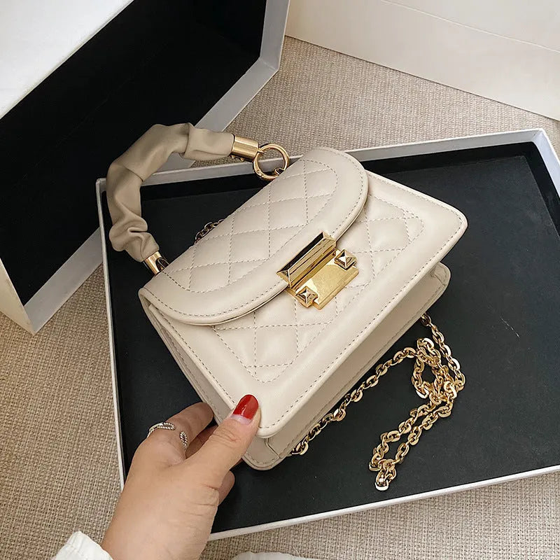 Purple rhombus-shaped small square ladies bag with chain-link shoulder strap on a white background