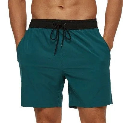 Men's blue running shorts with drawstring waist, stitching detail, and a headband pocket.
