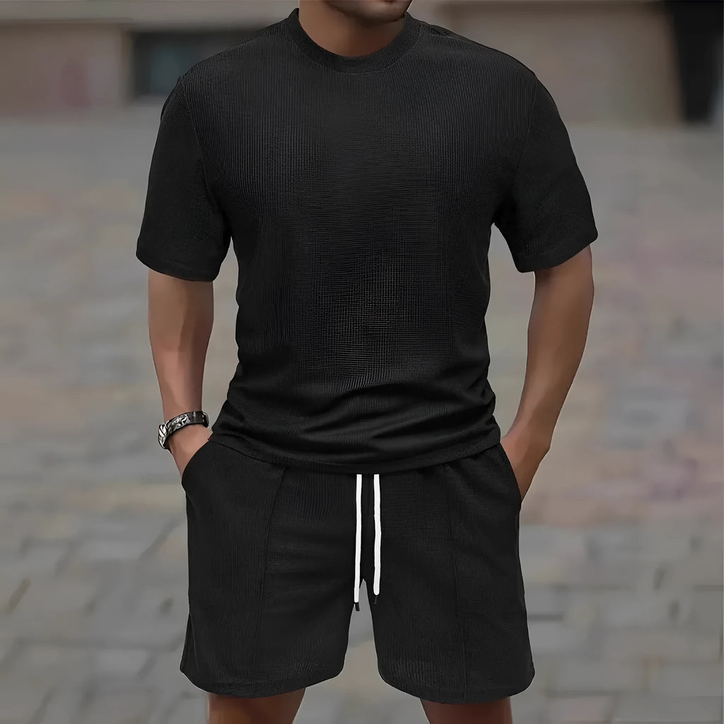 Man wearing a white waffle texture short sleeve blouse and matching shorts summer set.