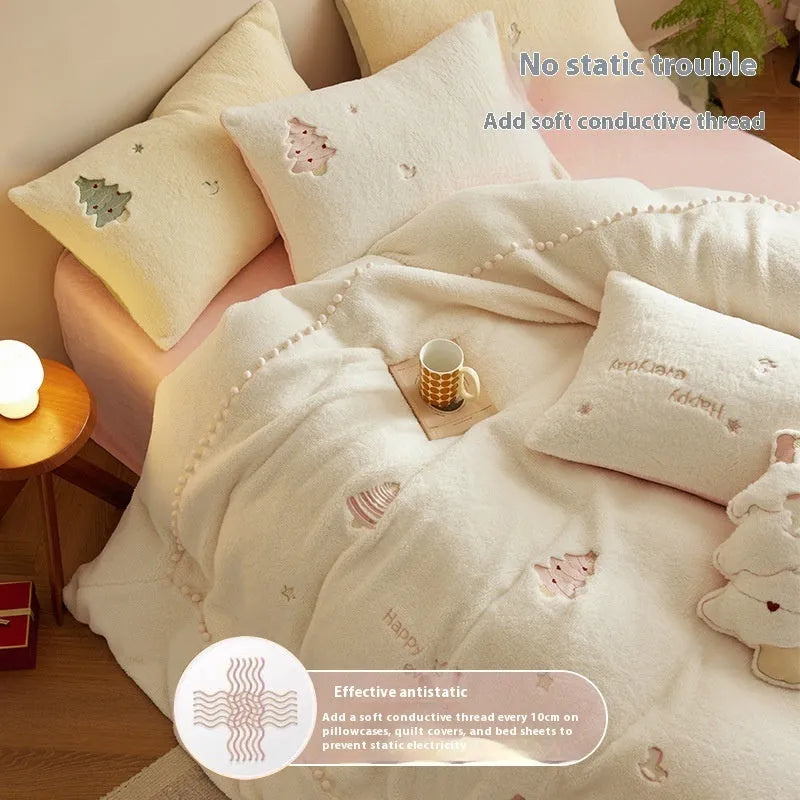 Winter milk fibre four-piece bedding set with printed green Christmas tree pattern on a bed.