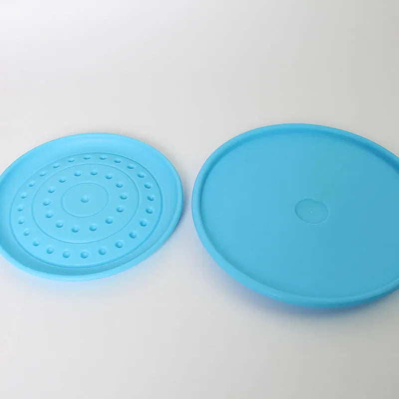 Plastic rubber dog Frisbee pet toy in assorted colours for outdoor fetch games.
