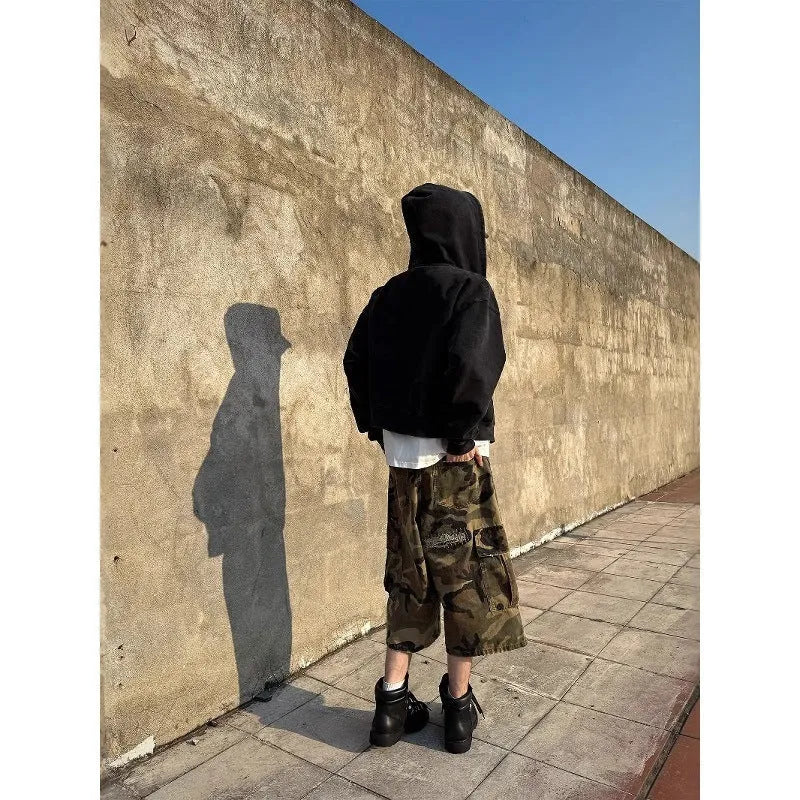 Men's loose-fit camouflage coloured cropped jeans with ripped details and straight-leg cut.