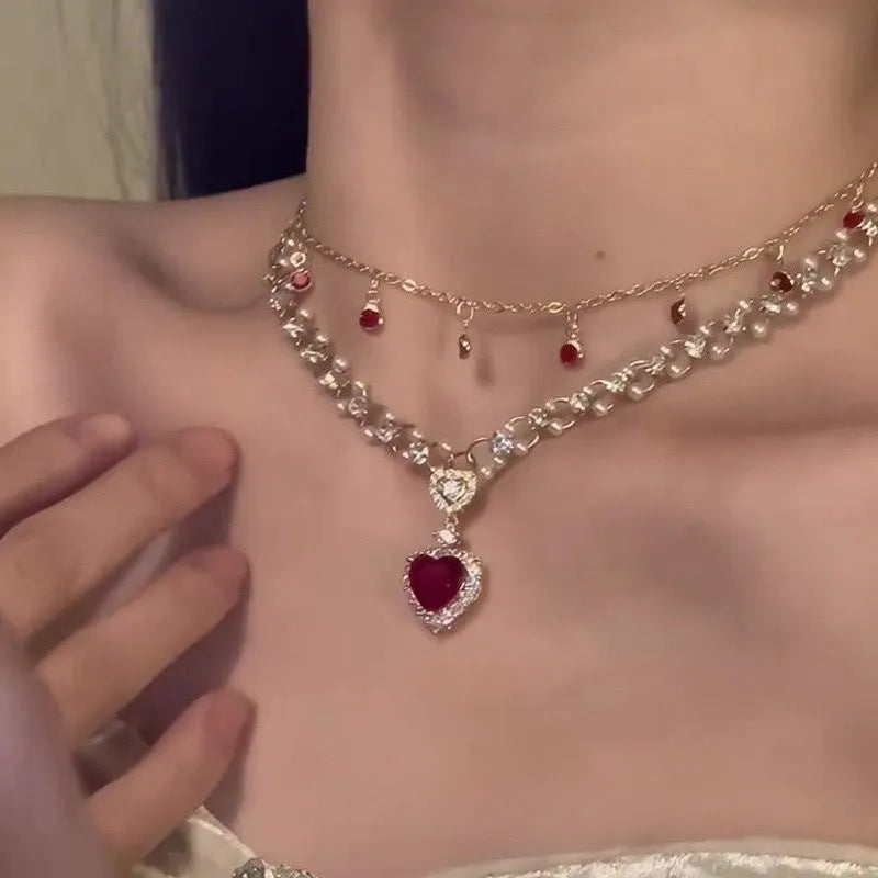 Red love heart and pearl charm on a double-layer adjustable alloy necklace.