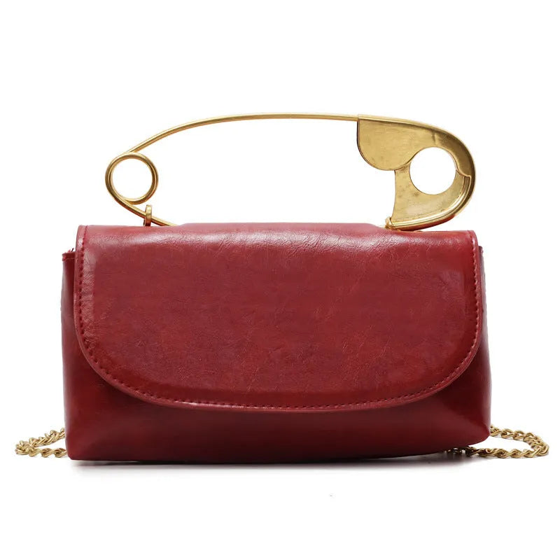 Creative Personality PU paper clip shoulder handbag in a horizontal square shape.