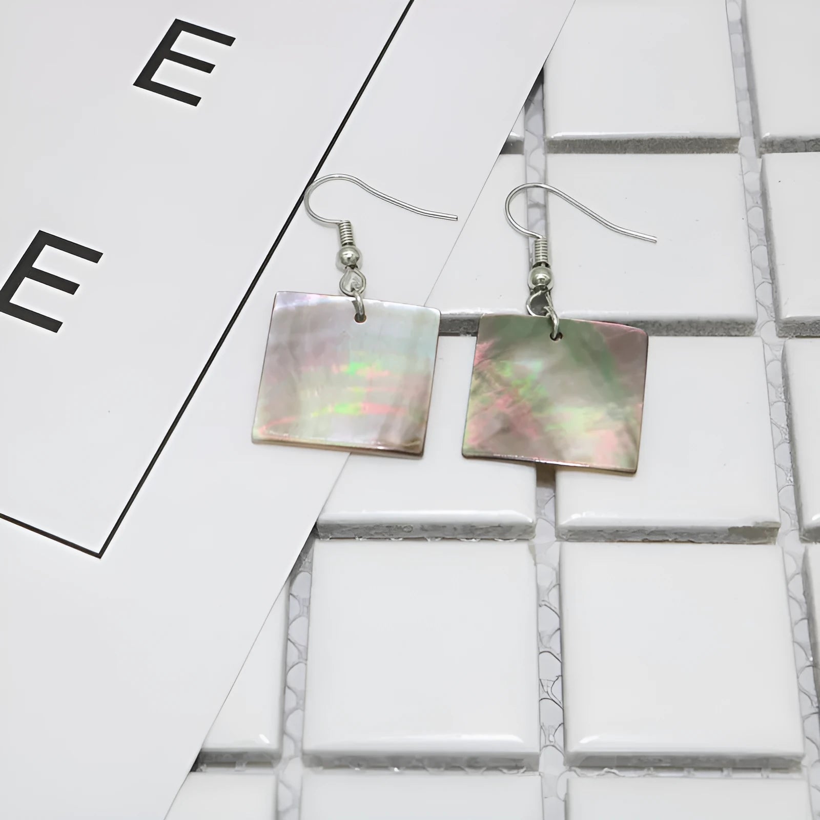 Geometric shell earrings in square panther or rectangular shell designs with natural finish