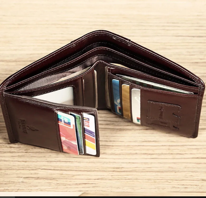 Men's brown leather bifold wallet open to show photo slot, card slots, billfold, and coin pocket.