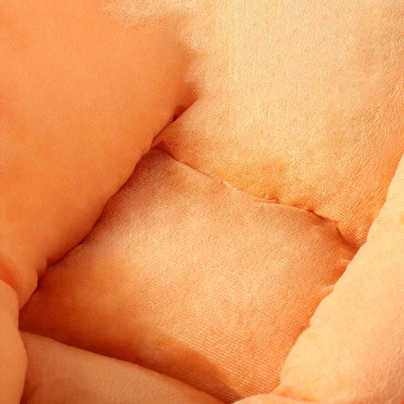 Carrot-shaped nesting dog bed with a soft blanket for small to medium-sized dogs.