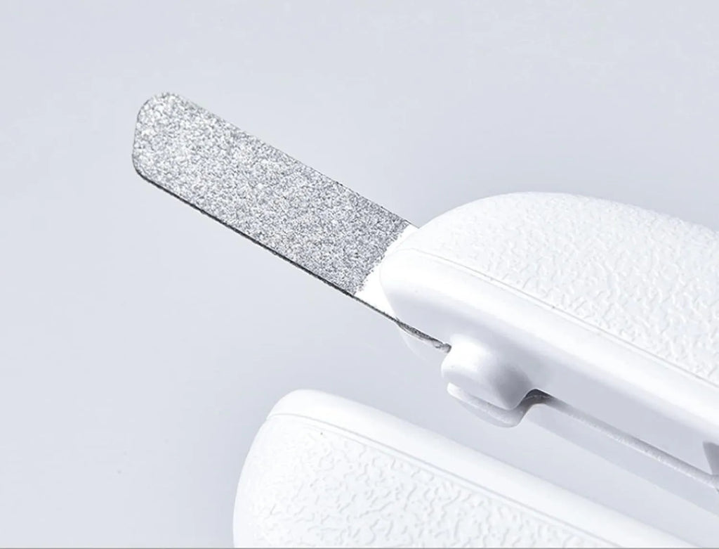 White pet nail clippers with LED light, transparent guard, and built-in file for cats and dogs.