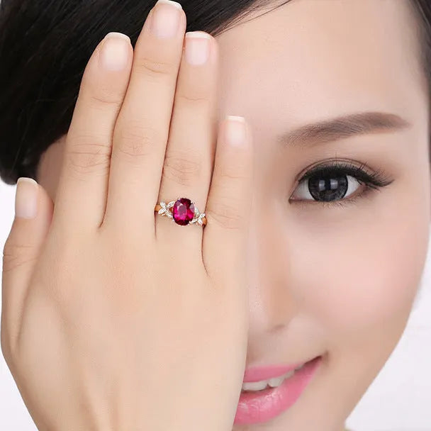 Women's butterfly and heart-shaped ring in copper with rose gold plating shown in red and blue colour options