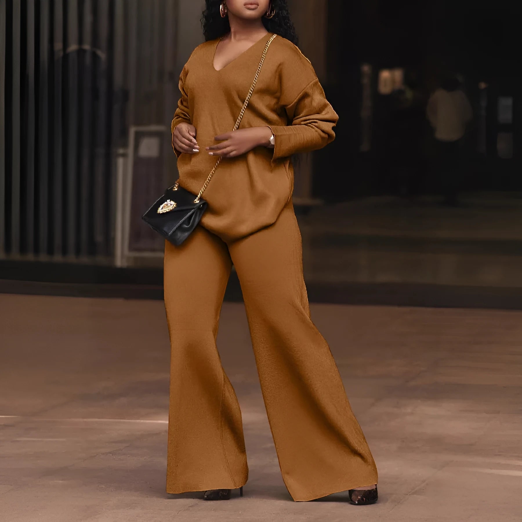Women's brown thick suede two-piece suit with long sleeves and trousers, laid flat.