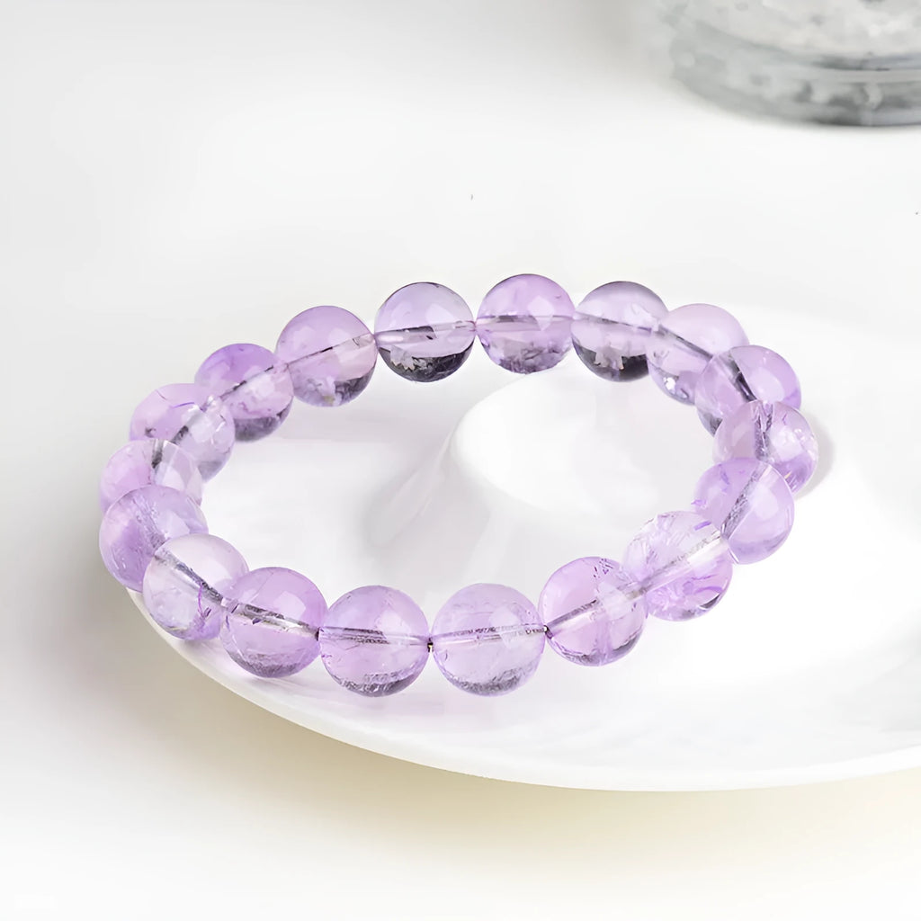 Lavender round amethyst bead bracelet with water ripple texture on a light background.