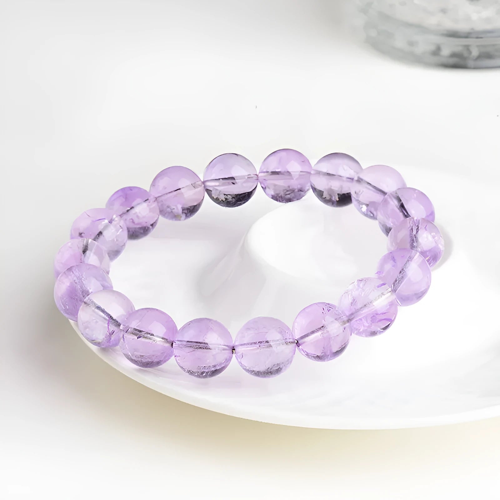 Lavender round amethyst bead bracelet with water ripple texture on a light background.