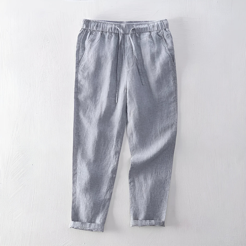 Men's straight leg linen trousers in light grey colour, showing mid waist and tailored fit.