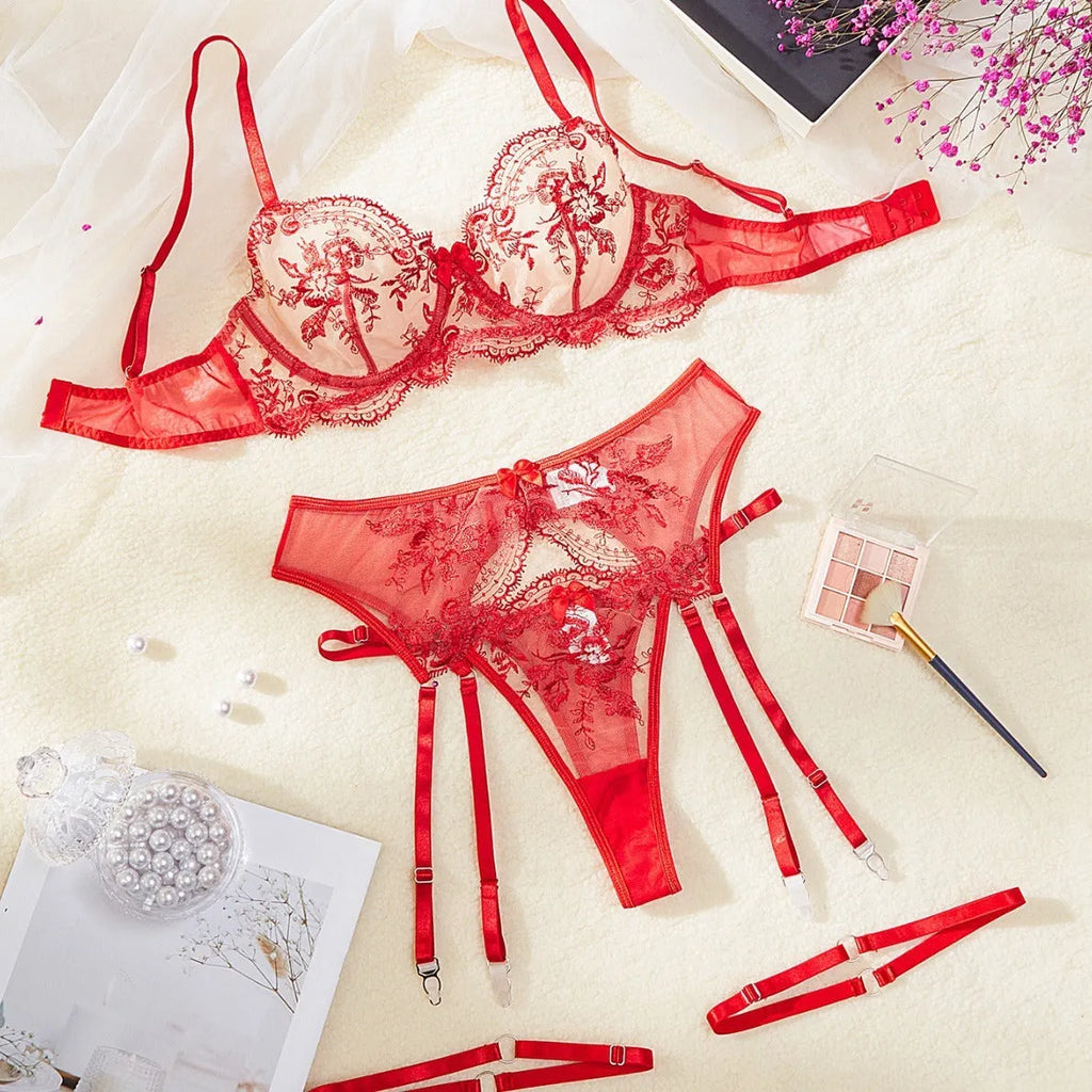 Women's embroidered see-through cutout lingerie set in polyester, shown in sapphire blue, including top, t-pants, and garters.