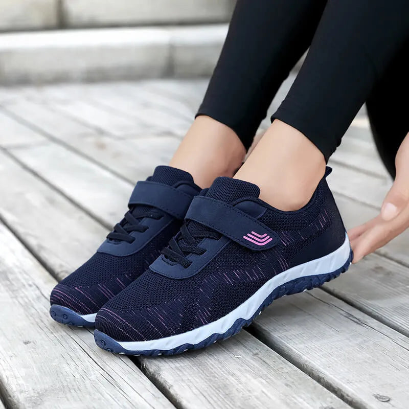 Women's low-top casual sneaker with mesh upper, wedge heel, and Velcro strap fastening.