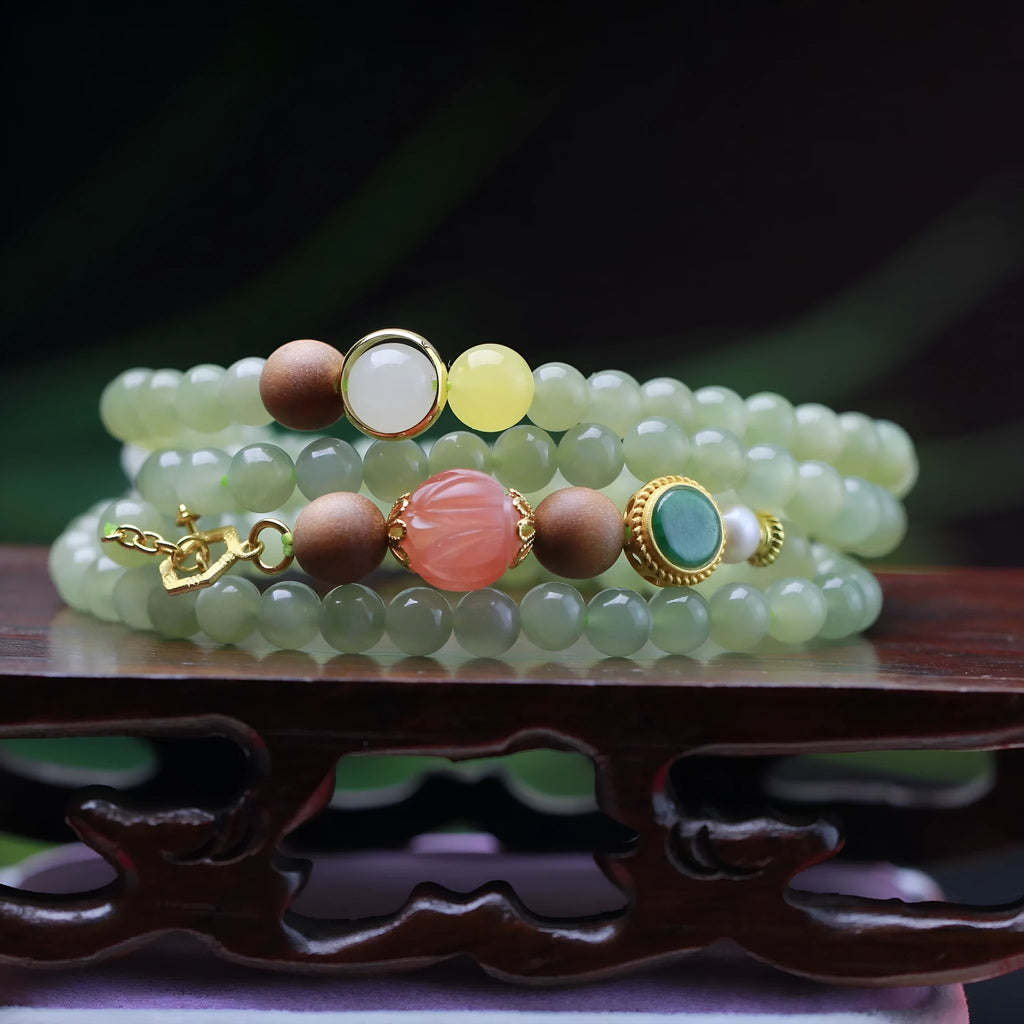 Hetian jade and sandalwood necklace with lotus beads and animal pendant, plus matching bracelet.