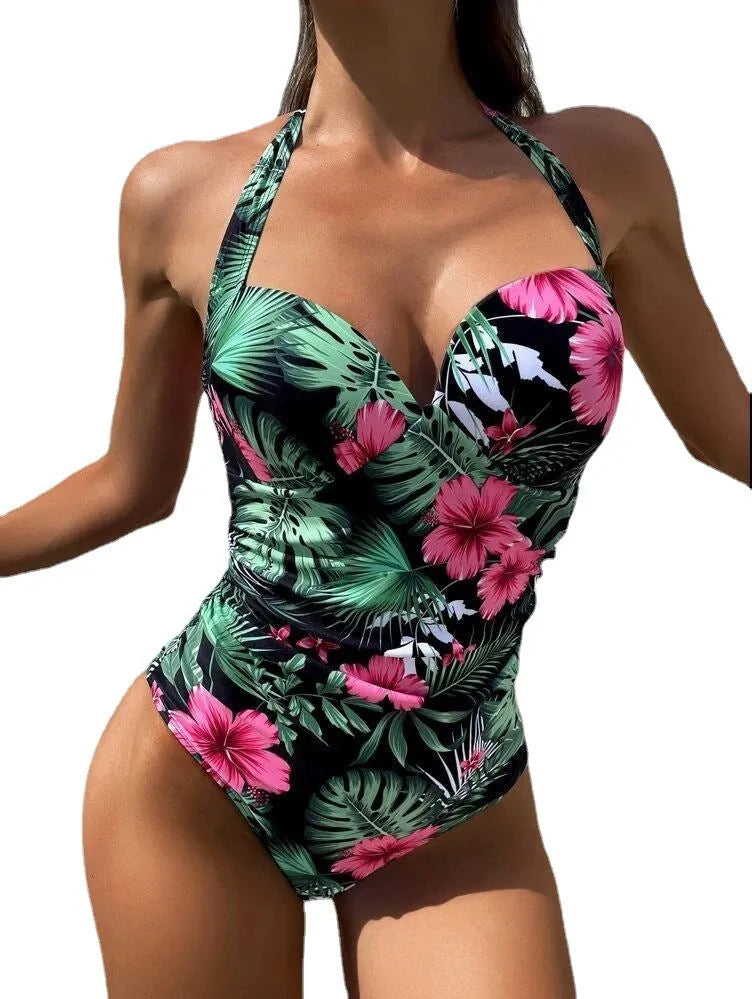 Women's printed halter-neck one-piece swimsuit on a mannequin, showing backless design.