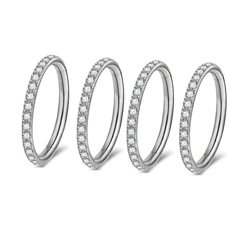 A stainless steel seamless nose ring with a diamond setting, shown in gold, rose gold, black, and steel finishes.