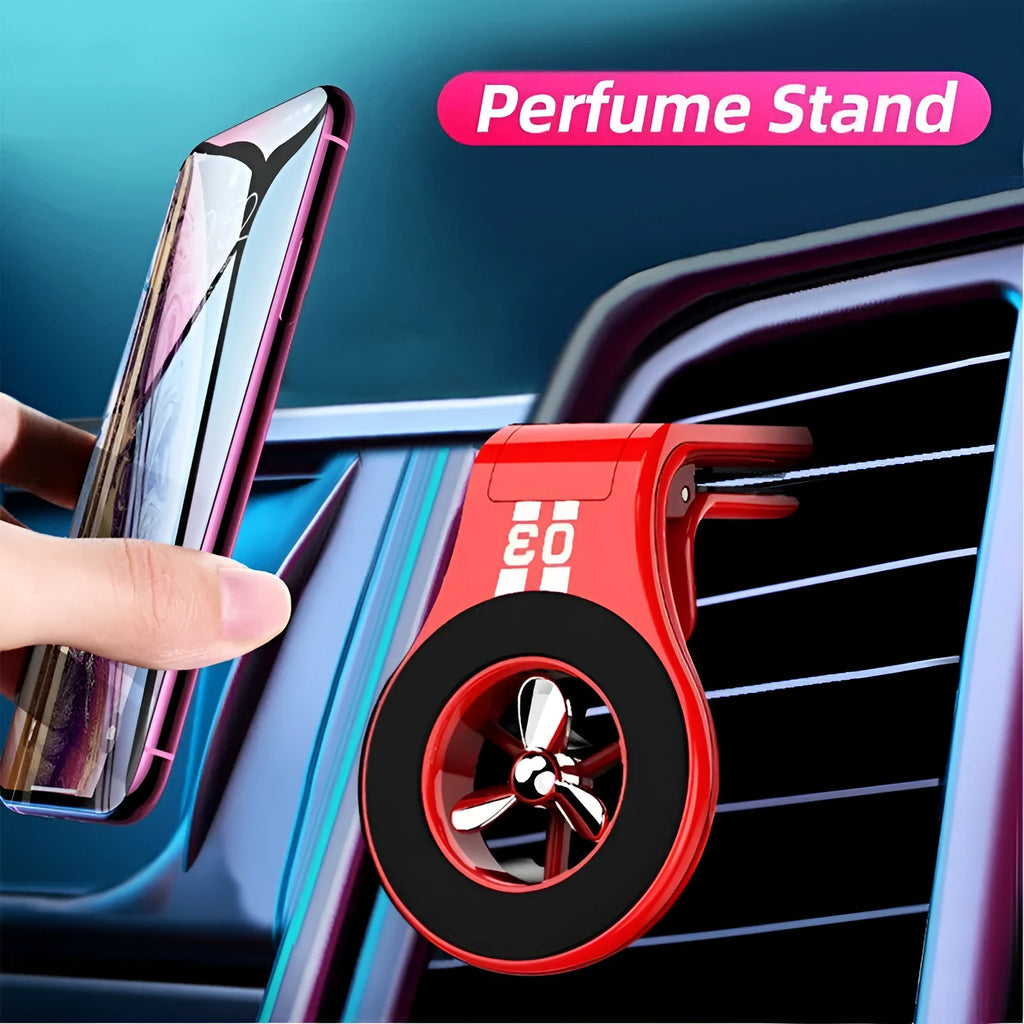 Black magnetic car air vent phone holder with adjustable head and fragrance slices attached to a vehicle vent.
