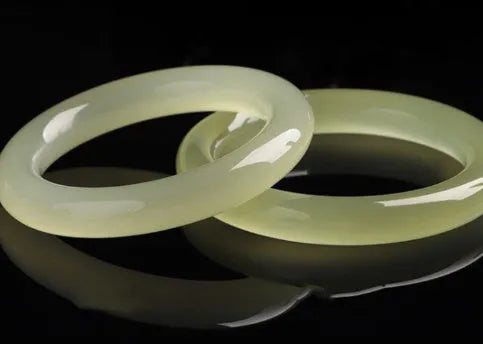 Round bar jade bracelet showing smooth geometric shape and cool stone finish.