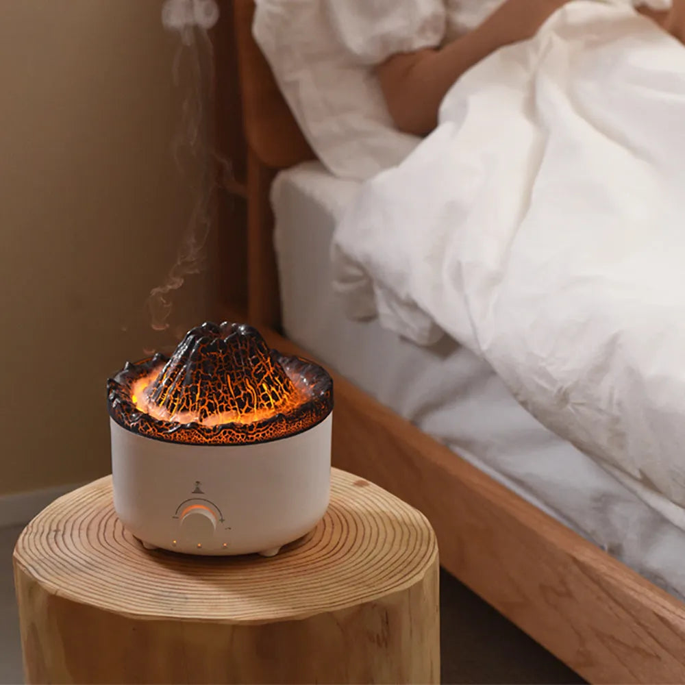White simulated flame volcano humidifier diffuser with remote control on tabletop