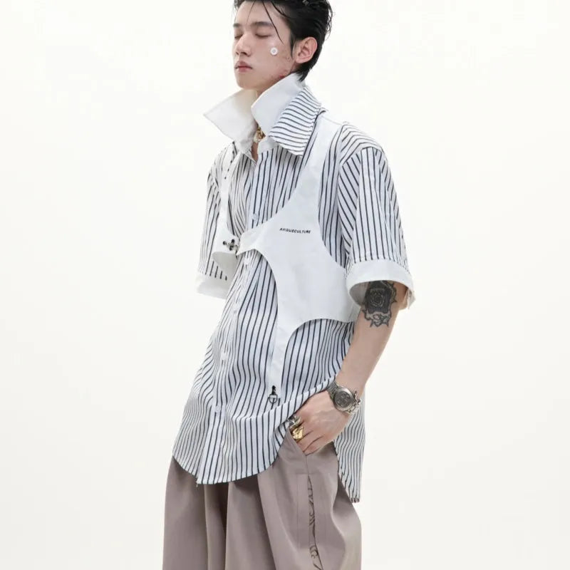 Man wearing a black and white striped short sleeve shirt with a distinctive double lapel collar design.