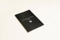 Black A5 hardcover dream journal notebook with lined paper and a ribbon bookmark.