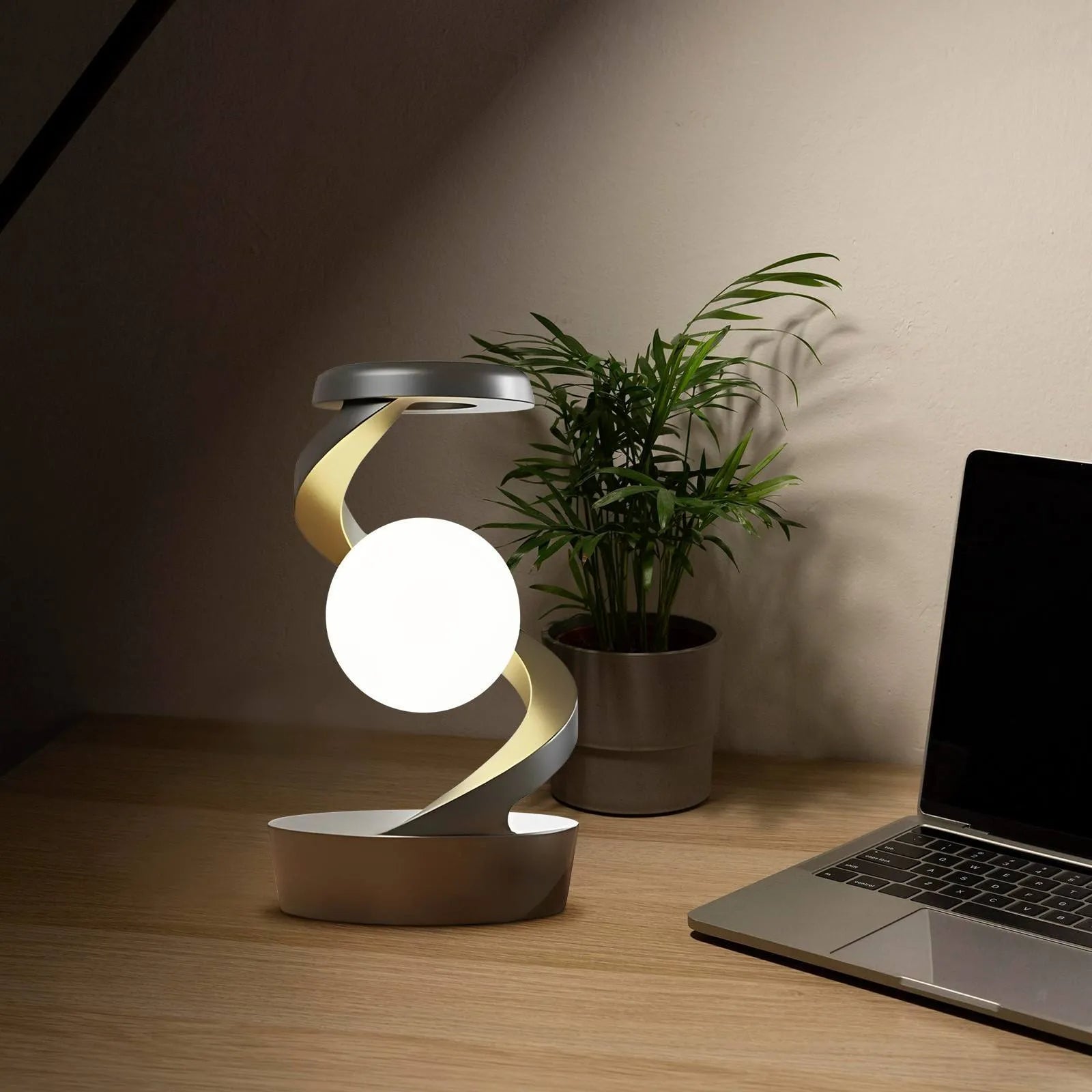 Rotating moon desk lamp with wireless charger in grey on a bedside table
