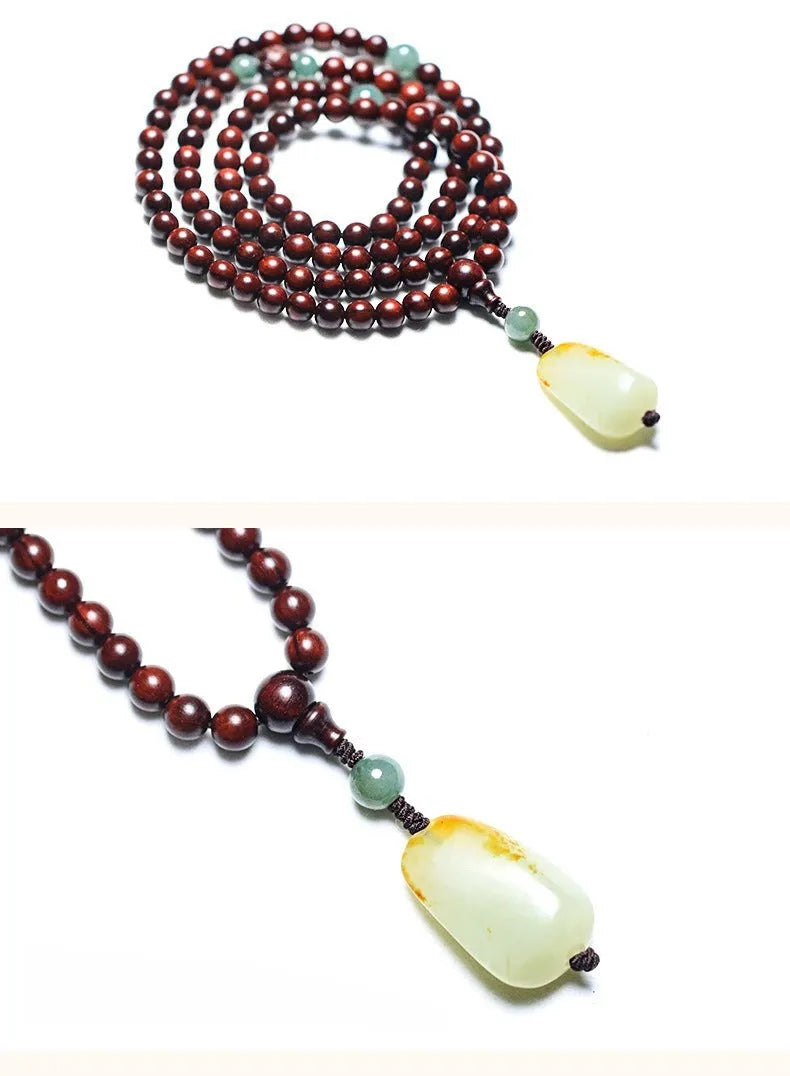 Carved rosewood bead bracelet with Hotian jade pendant showing wood grain texture