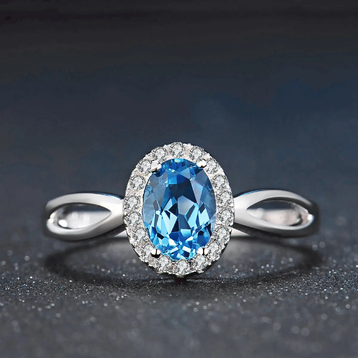 925 sterling silver four-piece jewellery set with blue topaz gems showing geometric earrings, ring, necklace, and pendant