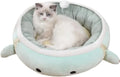 Green dinosaur-shaped cat bed with a chick inside, shown both flat and hanging as a hammock.