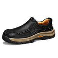 Men's black leather shoes with thick rubber soles and round toe design showing visible sewing thread construction