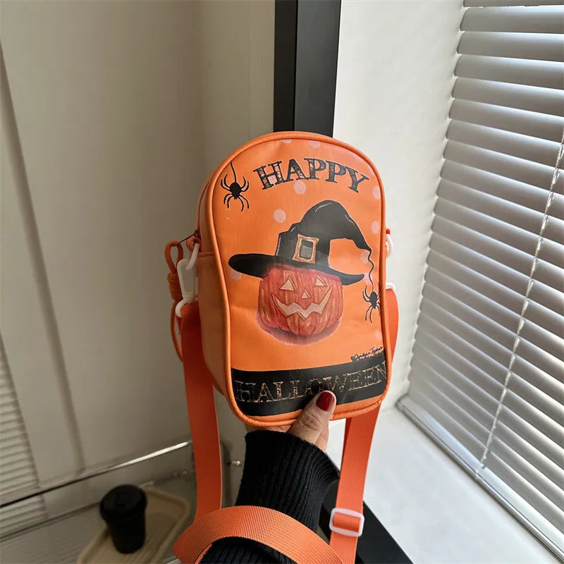 Black mini crossbody bag with Halloween graffiti print of cartoon pumpkins and bats.