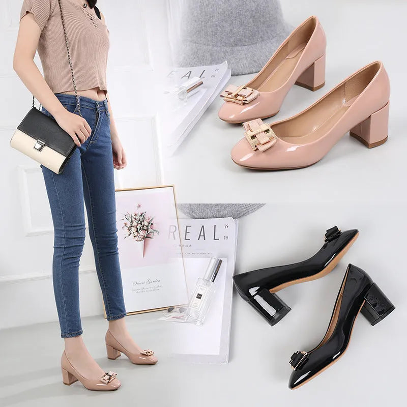 Mid heel round toe chunky heel pumps in solid colour with work buckle detail on a white background