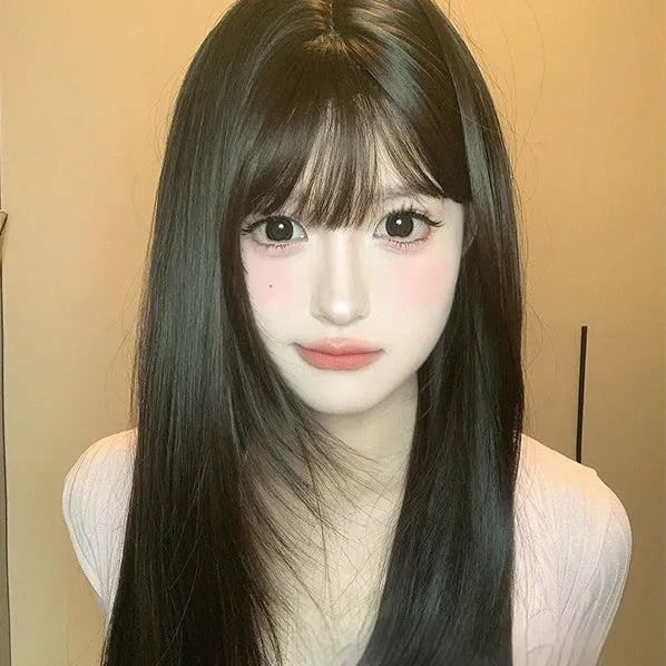 Dark brown long straight synthetic wig with bangs on a wig head.