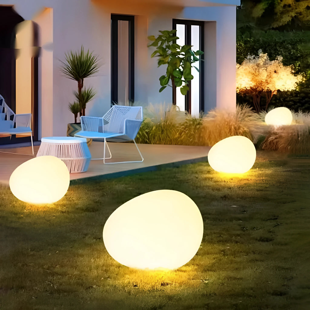 Outdoor pebble light in stone shape with IP65 waterproof rating, available in 26-48cm sizes for garden path, solar or rechargeable power options