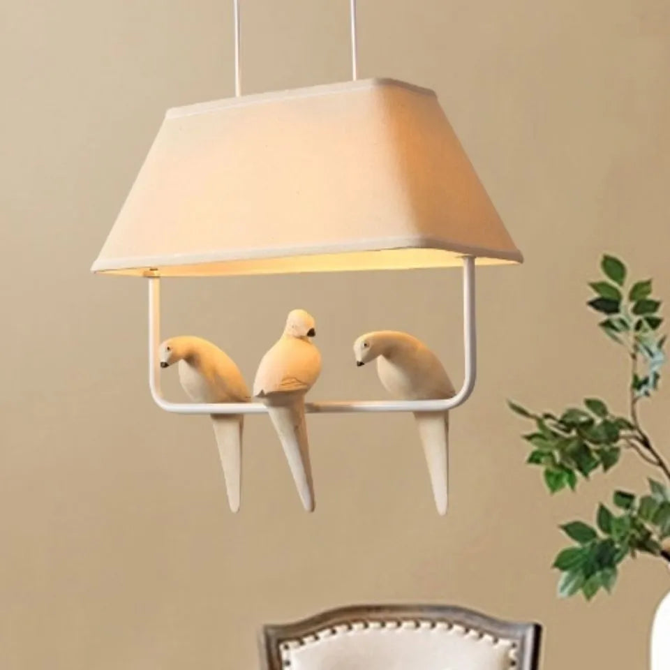 Bird chandelier ceiling lamp with iron frame and fabric shade in dining room setting