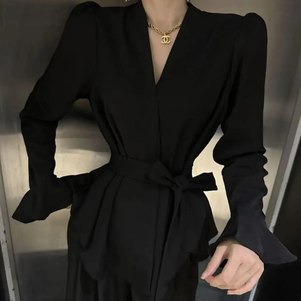 Women's black polyester shirt with a French-style irregular collar and long bell sleeves.