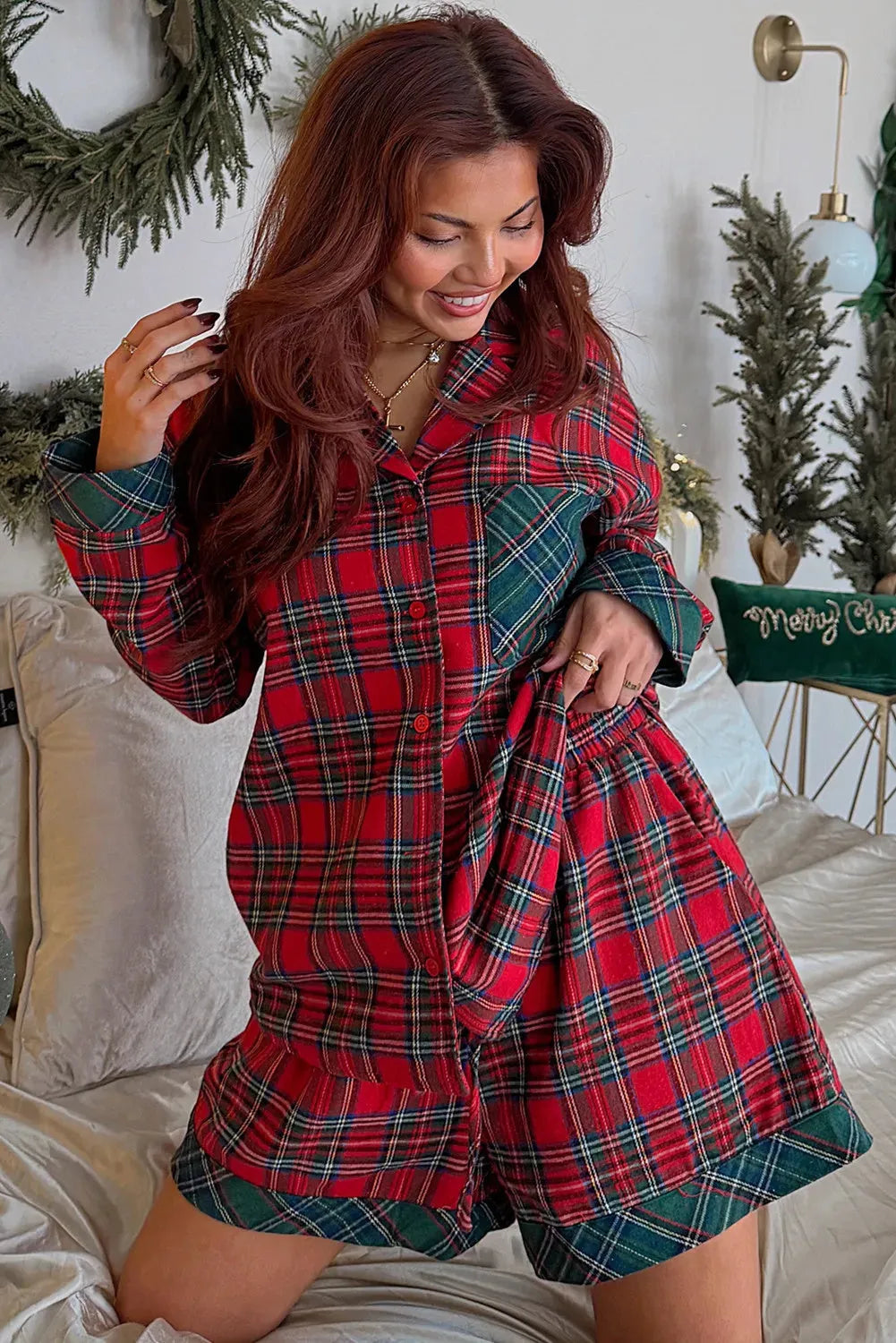 Red plaid Christmas pyjama set with contrasting fabric patches on shirt and shorts.