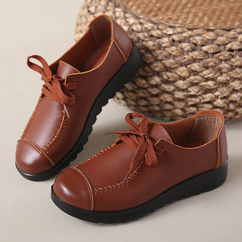 Women's black round toe flat work shoes with front lacing and soft anti-slip polyurethane sole