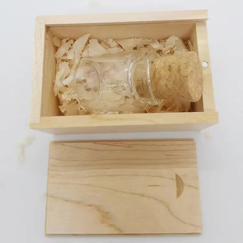 Transparent bottle-shaped USB flash drive on a wooden surface.