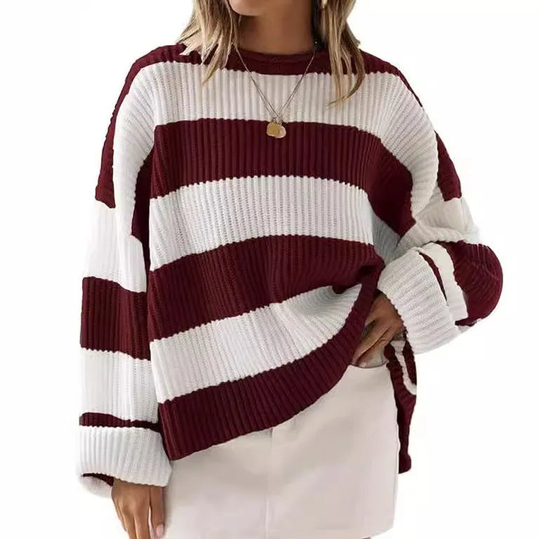 Women's striped loose sweater with bell sleeves and crocheted flower decoration.