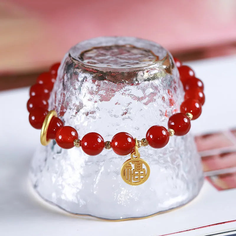 Handwoven natural red agate beaded bracelet with cultural style, shown with a blessing card.