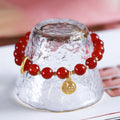 Handwoven natural red agate beaded bracelet with cultural style, shown with a blessing card.