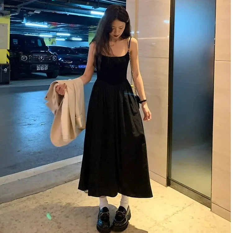 A-line slip dress in black with wide waist and sleeveless design made from polyester
